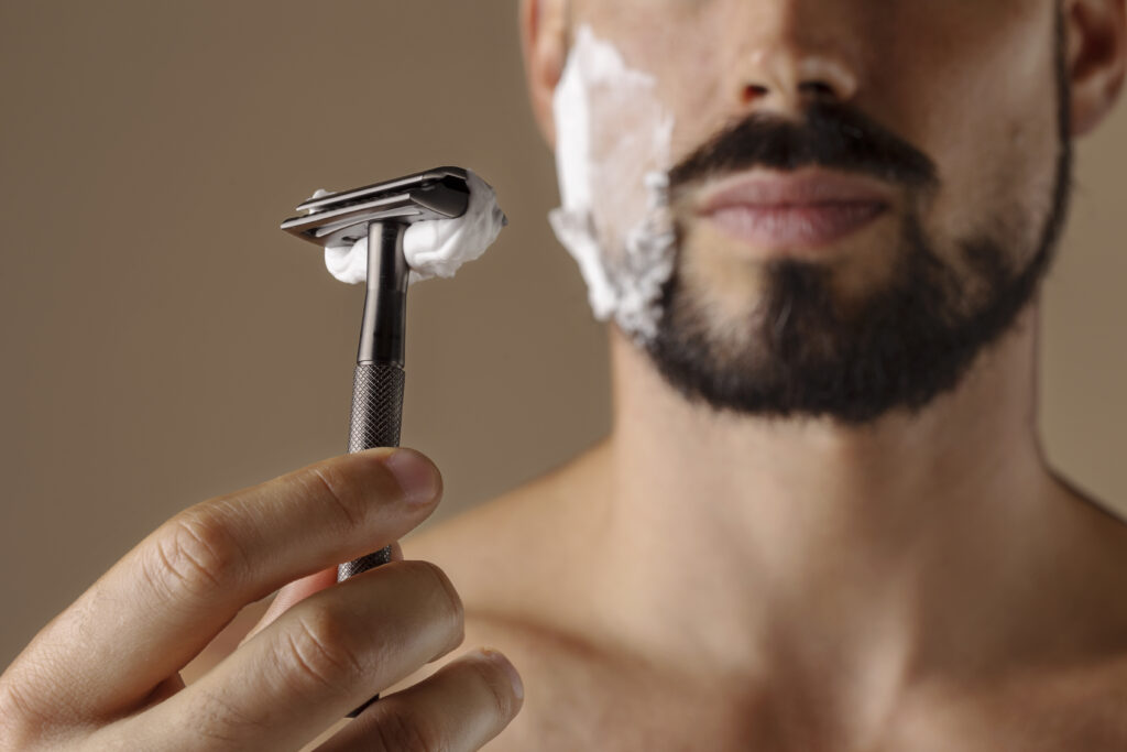 man shaving his beard.